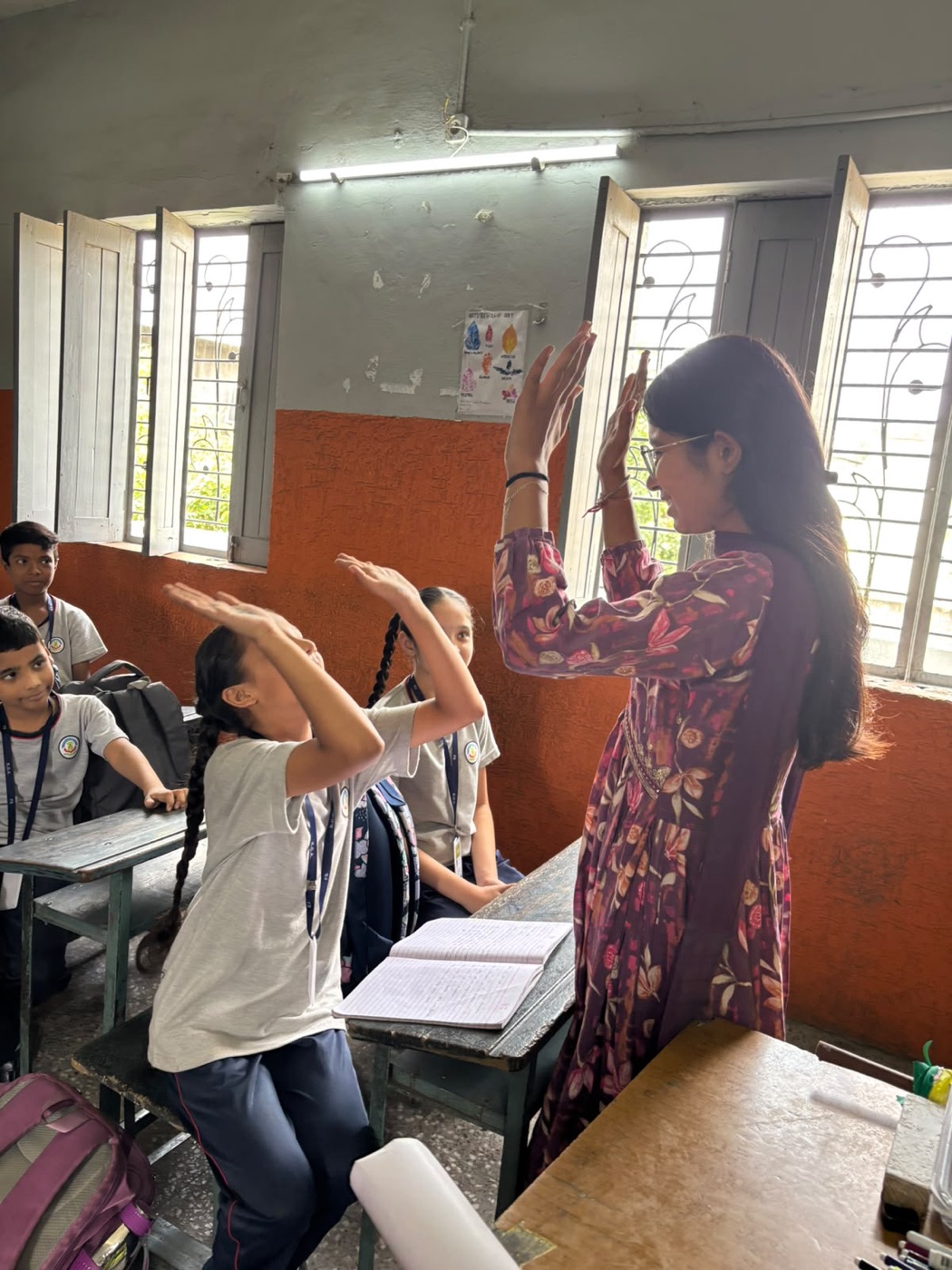 EFAS program manager working with students on a reading activity