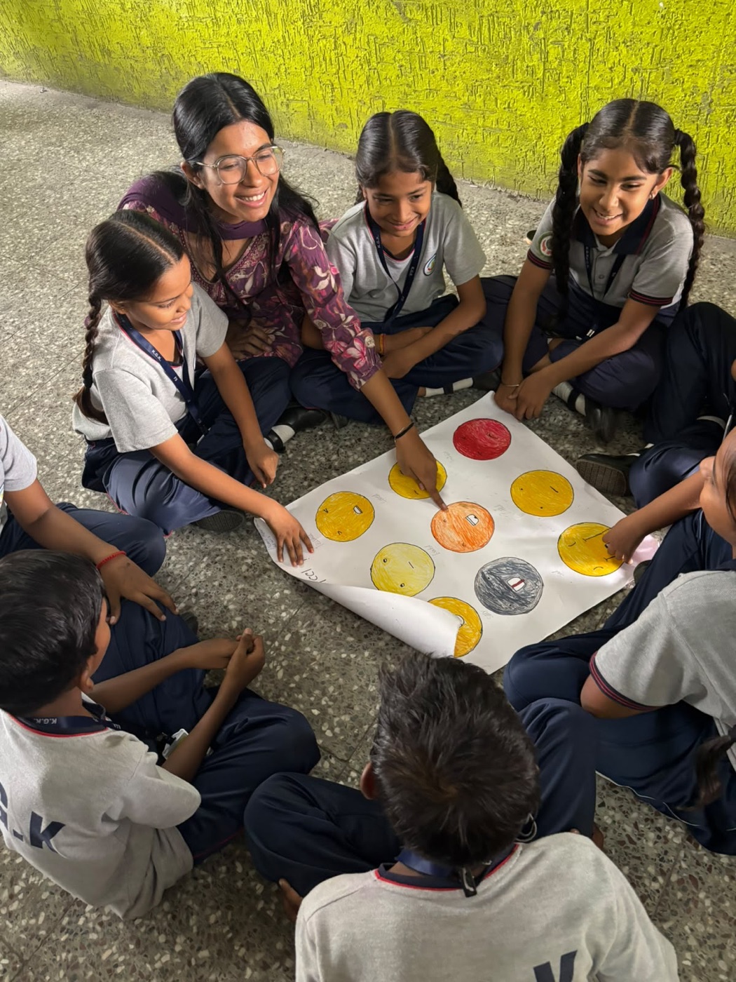 Students and teacher in a circle learning activity